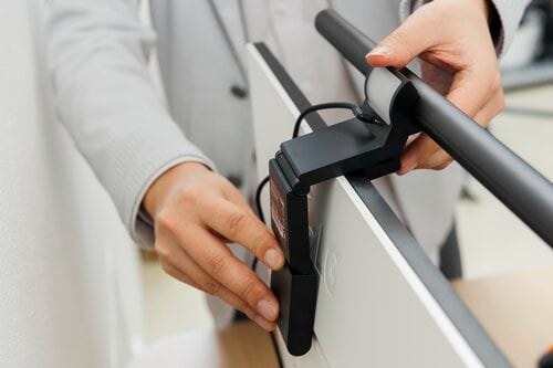 モニターライトをモニターに設置しているところ