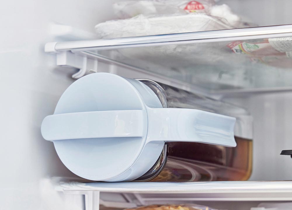 冷蔵庫の棚に横置きしている麦茶ポットの画像